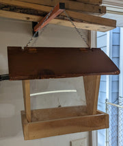 Bird Feeder made from cedar with hinged roof. 14 inches tall x 14 inches long x 10 inches wide, Holds 2 cups of birdseed.