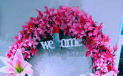 Wreath with lillies with the word WELCOME. 18 inch in diameter