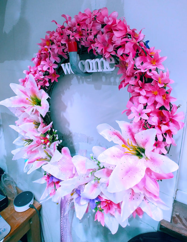 Wreath with lillies with the word WELCOME. 18 inch in diameter