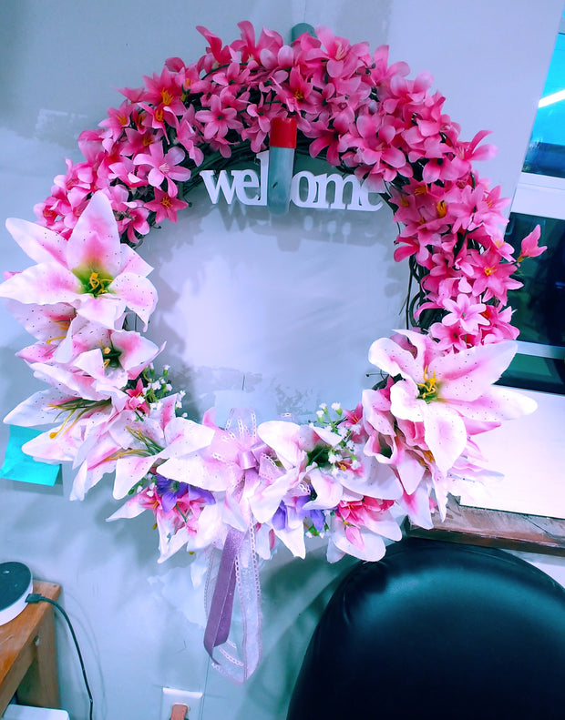 Wreath with lillies with the word WELCOME. 18 inch in diameter