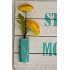 Decorative Sign Strong as a Mother and has two vases with flowers on each side
